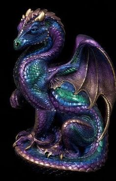 a purple and green dragon statue on a black background