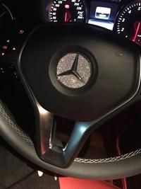 the steering wheel and dashboard of a mercedes benz benz - benz car, with its dash lights on