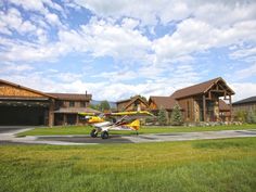 a small plane parked in front of a large house