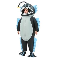 a young boy in a shark costume