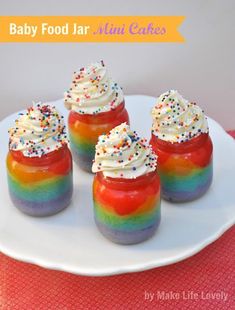 baby food jar mini cakes on a plate with sprinkles and rainbow colors