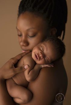 a woman holding a baby in her arms