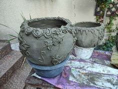 two clay pots sitting on top of a table