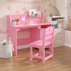 a child's desk and chair with pink paint on the walls in a room