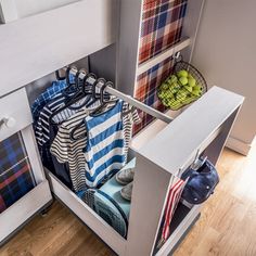 an open cabinet filled with clothing and other items