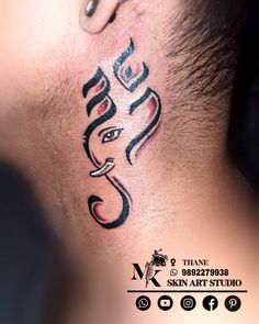 a close up of a person's neck with a tattoo design on the side