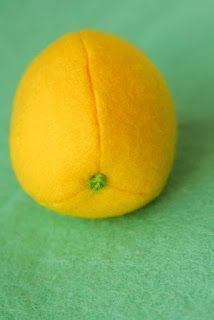 an orange sitting on top of a green surface