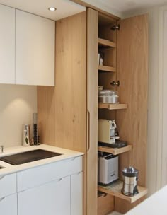 the kitchen is clean and ready to be used as a storage area for coffee makers