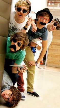 three men with fake mustaches are posing for the camera while one man is holding a knife