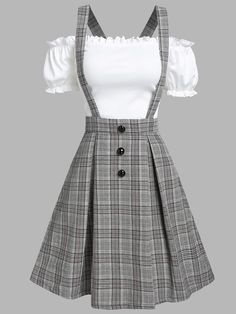 a woman wearing a plaid dress with white top and black suspenders on the waist