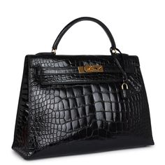 This vintage Kelly, in the Sellier style, is of Black Shiny Alligator Mississippiensis leather with gold hardware and has tonal stitching, a front toggle closure, a clochette with lock and two keys, a single rolled handle and a removable strap.The interior is lined with Black chevre leather and has one zip pocket with an Hermes engraved pull and two open pockets on the opposite side.Collection: V Circle Origin: FranceCondition: Vintage; Excellent - This bag retains its shape. There is no plastic Hermes Kelly Sellier, Hermes Kelly 32, Hermes Vintage, Kelly 32, Vintage Kelly, Kelly Sellier, Black Alligator, Hermes Birkin 25, Vintage Hermes