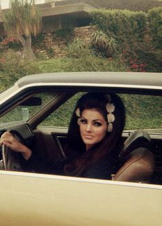 a woman sitting in the driver's seat of a car