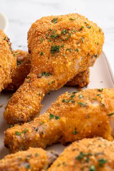 some fried chicken on a plate with dipping sauce