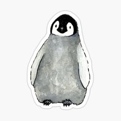 a penguin sticker sitting on top of a white surface