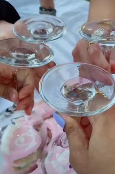 several people holding wine glasses in their hands