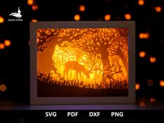 a paper cut of a deer in the woods at night with lights behind it and text that reads, svg df dxf dxf png