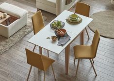 a dining table with chairs around it in a living room