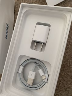 an apple charger and usb cable in a box