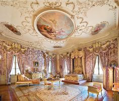 an ornately decorated bedroom with paintings on the walls and ceiling is pictured in this image