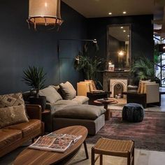 a living room filled with furniture and a fire place in the middle of it's wall