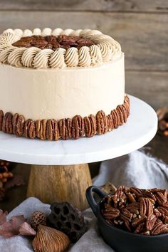 there is a cake with pecans on the side