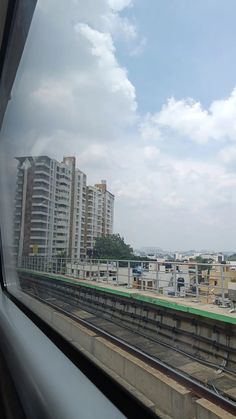 a train traveling down tracks next to tall buildings