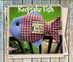 a fish stuffed animal sitting on top of a wooden bench with the words keepake fish