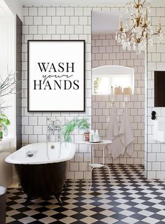 a black and white bathroom with a claw foot tub