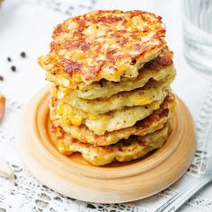 a stack of pancakes sitting on top of a wooden plate