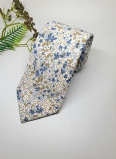 "I AM CURRENTLY AWAY FOR THE MONTH OF DECEMBER. YOU ARE WELCOME TO  PLACE YOUR ORDER, HOWEVER ALL ORDERS WILL BE SHIPPED OUT IN THE FIRST WEEK OF JANUARY. PLEASE FEEL FREE CONTACT ME IF YOU HAVE ANY QUESTIONS.Store Home Page - https://ivoryrosebridalau.etsy.com The Agean Blue cotton mens tie  is the perfect tie for the groom or groomsmen on their wedding day.  It features petite blue and green flowers on a beige background. Made  from 100% Cotton Tie Width - 7 cm or 2.75\" Length - 145cm or 57\" Adjustable White Tie For Wedding, Green Tie Wedding, Floral Tie Groomsmen, Agean Blue, Blue Floral Tie, Groomsmen Tie, Blue And Green Flowers, Husband To Be, Aegean Blue