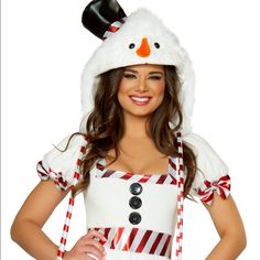 a woman wearing a snowman hat and dress with candy canes on her chest