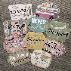 various travel stickers sitting on top of a carpet