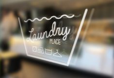 blurry image of a window with the words laundry place written in white on it