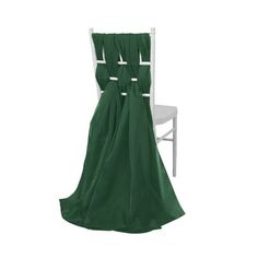 a chair with a green cover on it and a white chair in the back ground