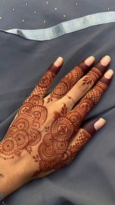 a woman's hand with henna on it