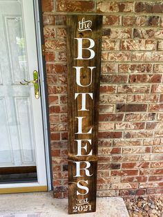 a wooden sign that says the busters on it in front of a brick building