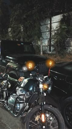 two motorcycles parked next to each other in front of a black car and another vehicle