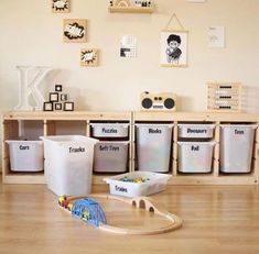 a room with toys and bins on the floor