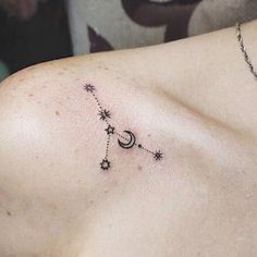 a woman's chest with stars and the moon on it