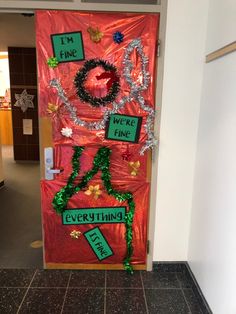 a door decorated with green and red tinsels that says i'm fine we're fine everything else