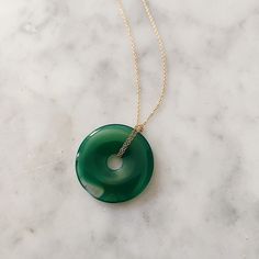 The sweetest donut—only you can’t eat it. Our Beignet Necklace is a great example of when minimalist meets maximalist. A dainty necklace is paired with a statement donut stone pendant to make something extraordinary. Choose your stone according to your flavor. 16", 18", 20", 22" Cable Link Chain Options 30mm Round Green Agate, Each Stone Unique No two stones are alike 14k Yellow Gold Filled or Sterling Silver Made in New York City Made to order, please allow 5-10 business days for production Top Rings, Green Agate, Green Necklace, Birthstone Necklace, Dainty Necklace, Stone Pendant, Signet Ring, Accessories Necklace, Vintage Accessories