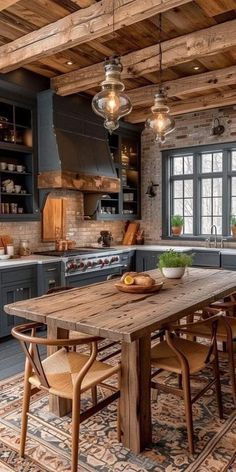 a large kitchen with wooden floors and gray cabinets, along with an old - fashioned dining table