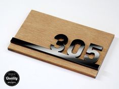 a wooden plaque with the number 350 on it