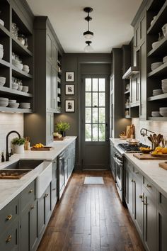 a kitchen with gray cabinets and white counter tops, wooden flooring and open shelving