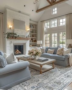 a living room filled with furniture and a fire place in the middle of a room