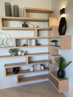 a room with shelves and vases on the wall