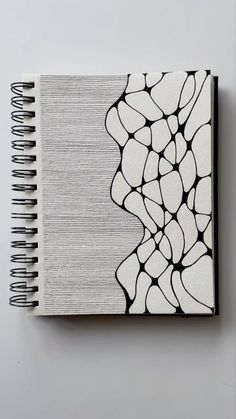 a notebook with black and white designs on it