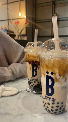 two iced drinks sitting on top of a table