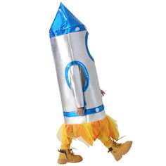 a person in a costume walking with a rocket ship on it's back legs