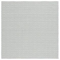 a white and grey rug with diamond shapes